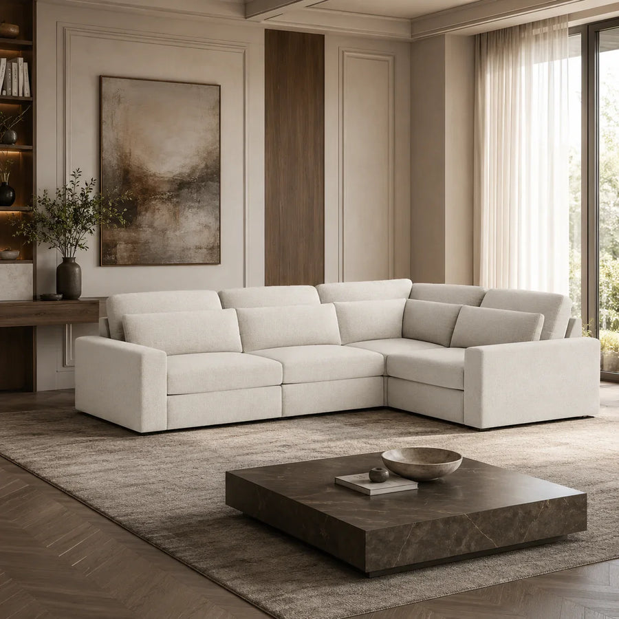 Luxury beige sectional sofa in modern living room with marble coffee table and abstract art