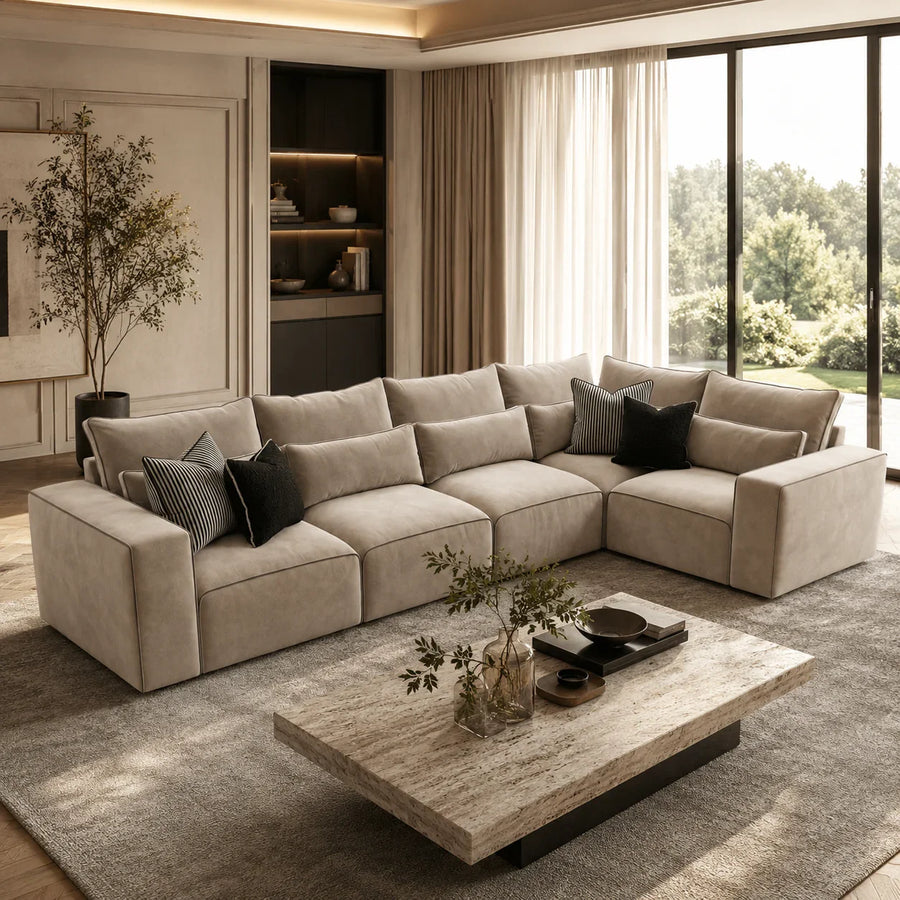 Luxury beige sectional sofa with black throw pillows in modern living room, perfect for UK homes