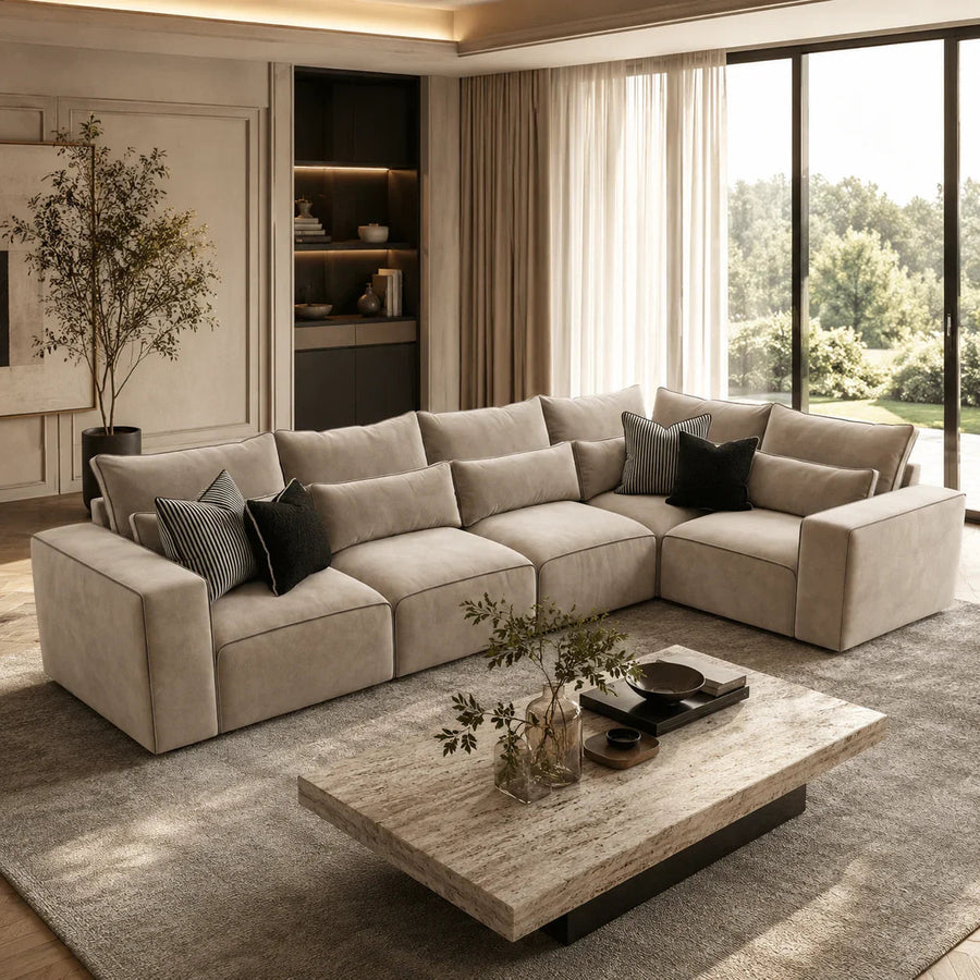 Luxury beige sectional sofa with black throw pillows in modern living room, perfect for UK homes
