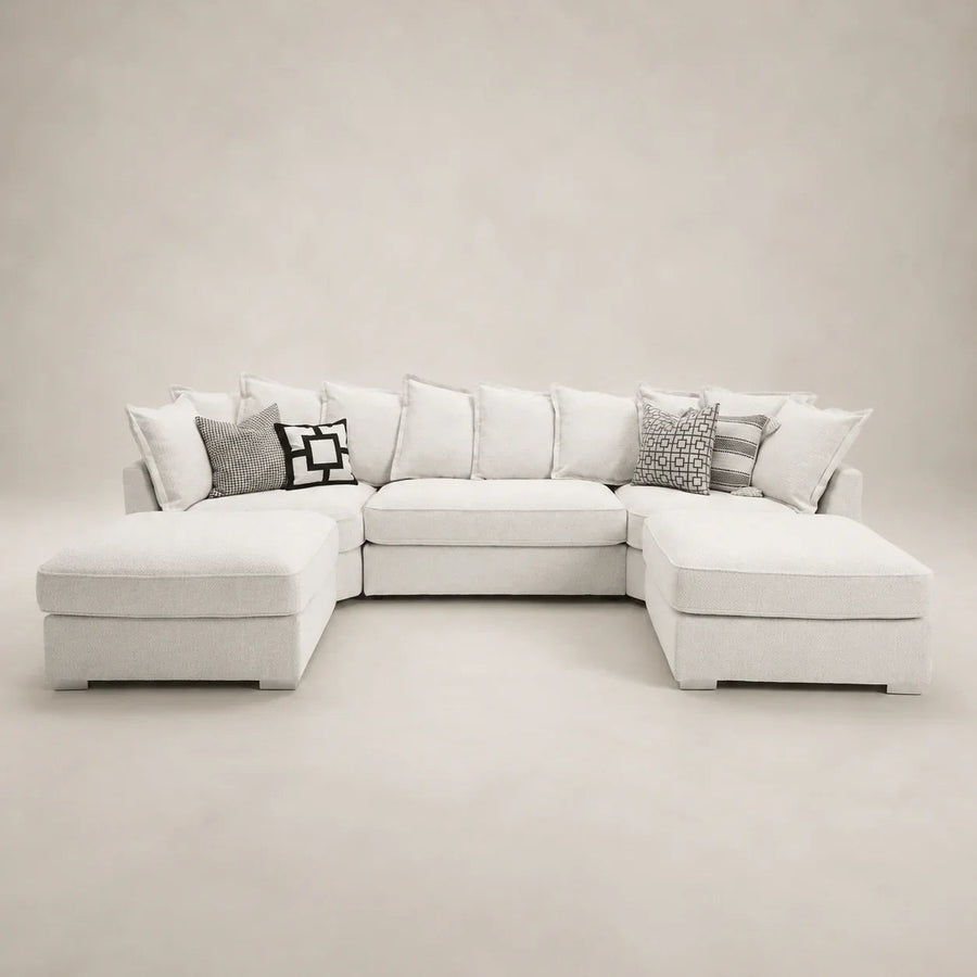 Luxury white sectional sofa with chaise lounges and patterned throw pillows, perfect for modern living rooms.