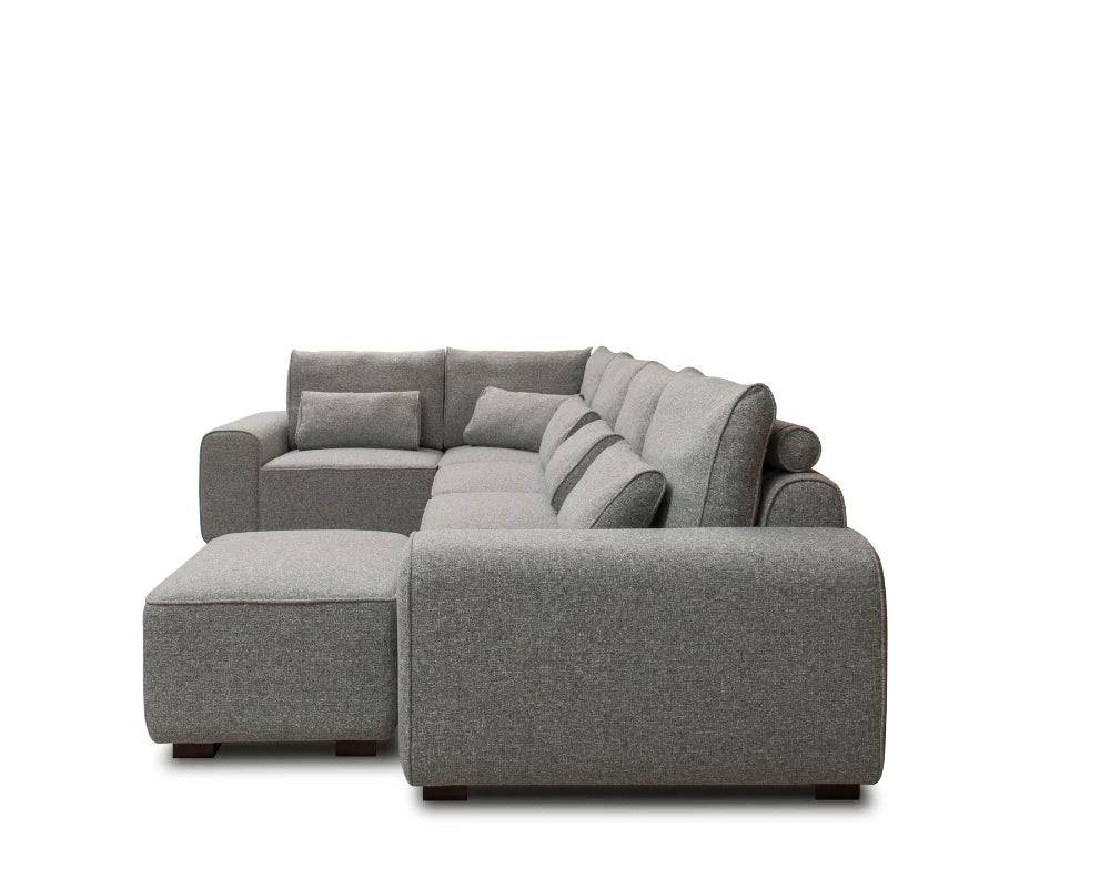 Modern grey corner sectional sofa with chaise and matching cushions on white background