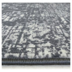 Grey and white distressed pattern area rug with plush texture and bound edge
