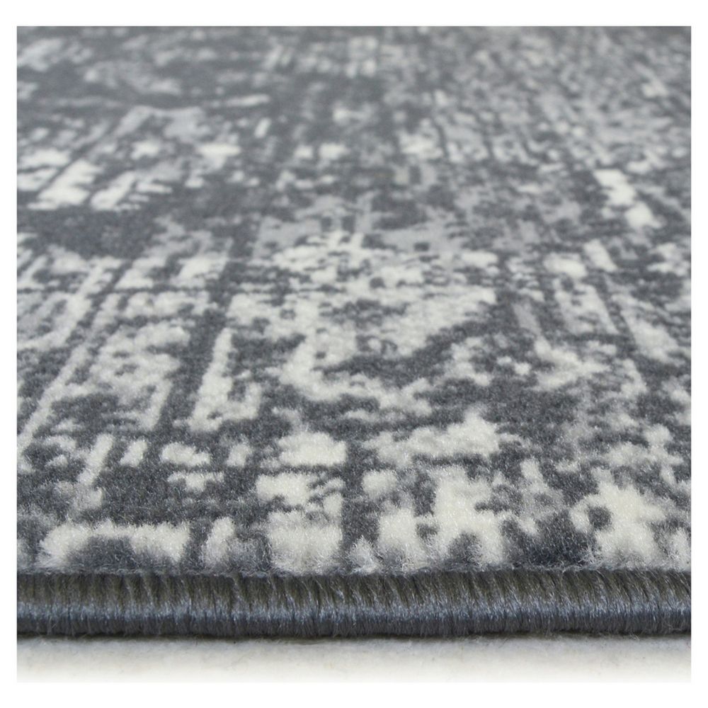 Grey and white distressed pattern area rug with plush texture and bound edge