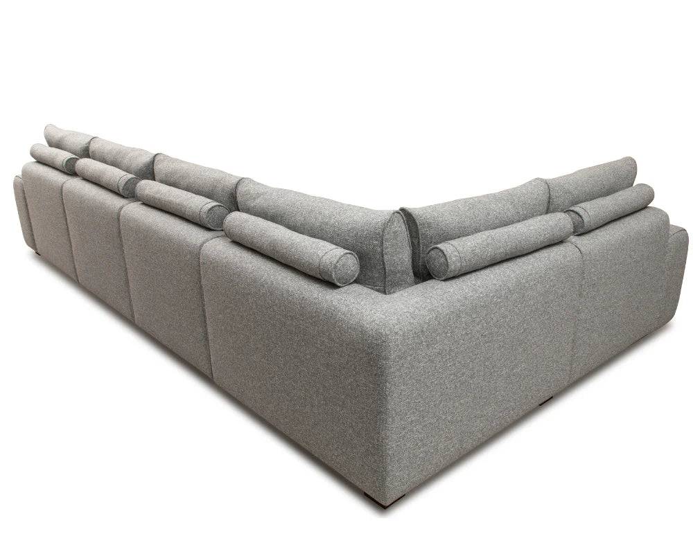 Modern grey corner sofa with adjustable headrests and plush upholstery, back angle view