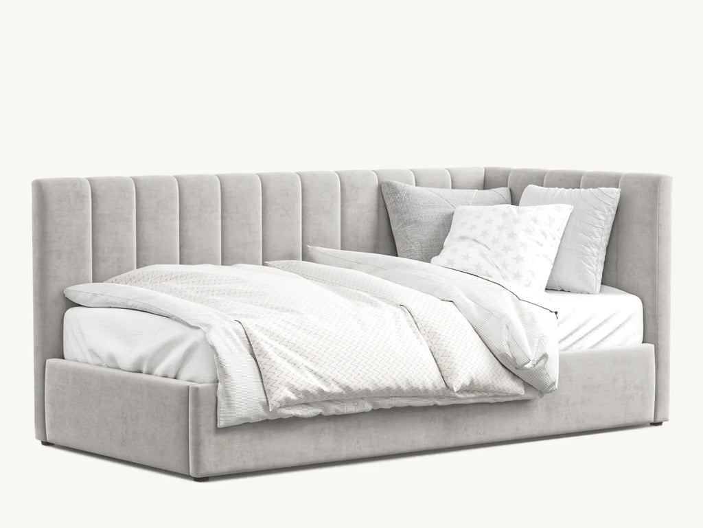 Luxury upholstered corner bed with vertical panel headboard, plush bedding and pillows