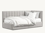 Luxury upholstered corner bed with vertical panel headboard, plush bedding and pillows