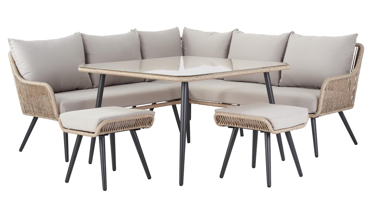 Luxury outdoor wicker sofa set with glass table and matching stools, perfect for patio dining