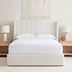 Modern upholstered bed with vertical panel headboard, flanked by wooden bedside tables and lamps