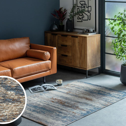 Luxury brown leather sofa with modern abstract rug in stylish living room setting
