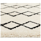 Cream shaggy rug with black diamond pattern, cozy living room floor decor