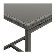 Grey woven rattan outdoor table with glass top, modern patio furniture detail