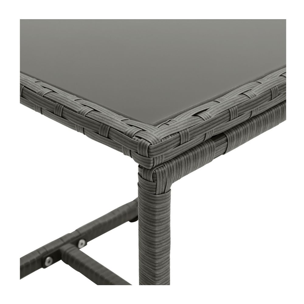 Grey woven rattan outdoor table with glass top, modern patio furniture detail