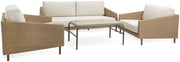 Wicker outdoor sofa set with cream cushions and glass-top table, perfect for patio or garden seating.