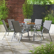 Modern grey outdoor dining set with 6 chairs on stone patio, perfect for garden entertaining