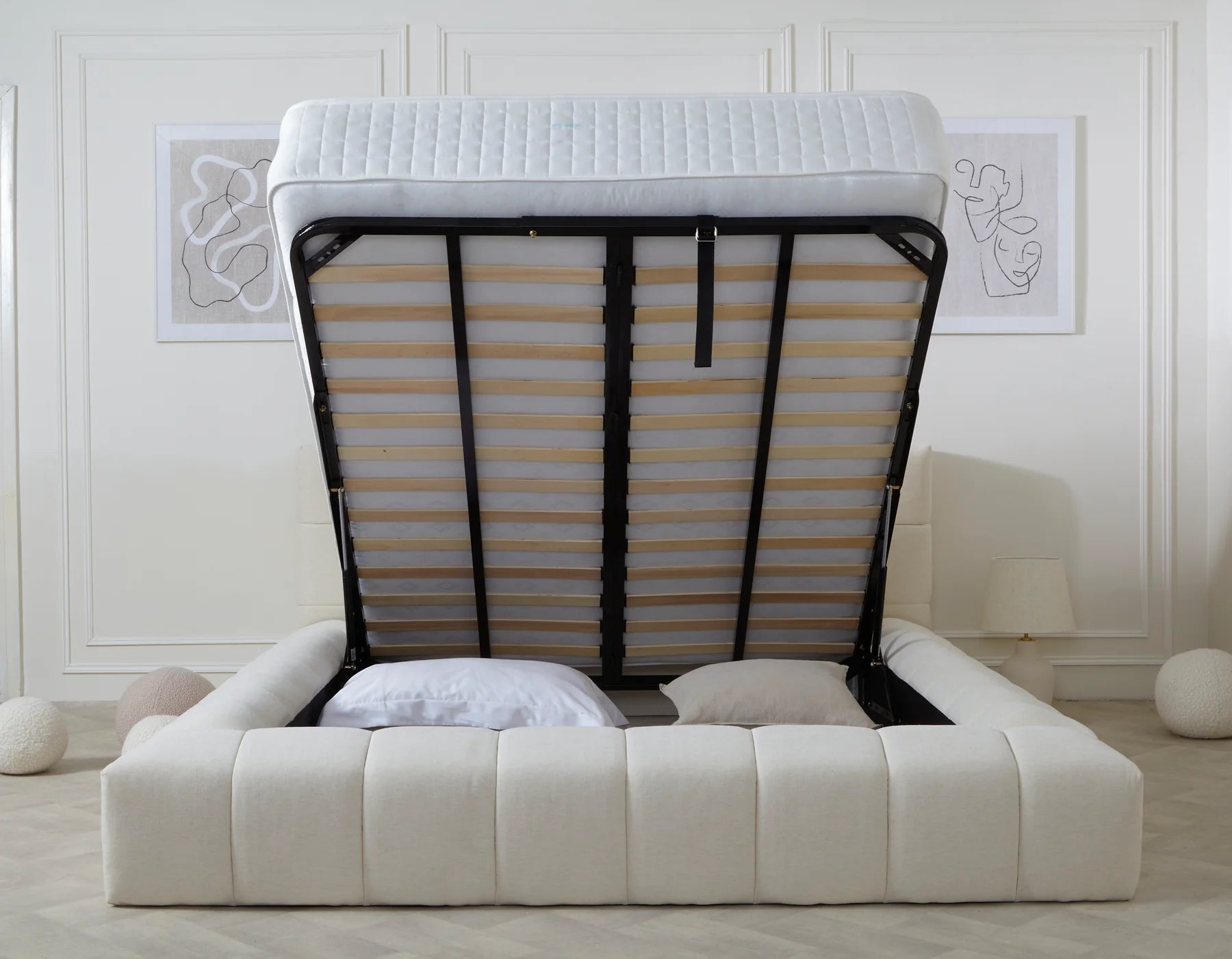 Upholstered storage bed with lifted mattress in a modern bedroom with minimalist decor