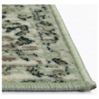 Green patterned area rug with braided edge, ideal for living room or bedroom decor