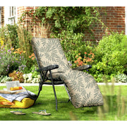 Leaf-patterned outdoor recliner chair on lawn with garden backdrop, perfect for relaxing in style.