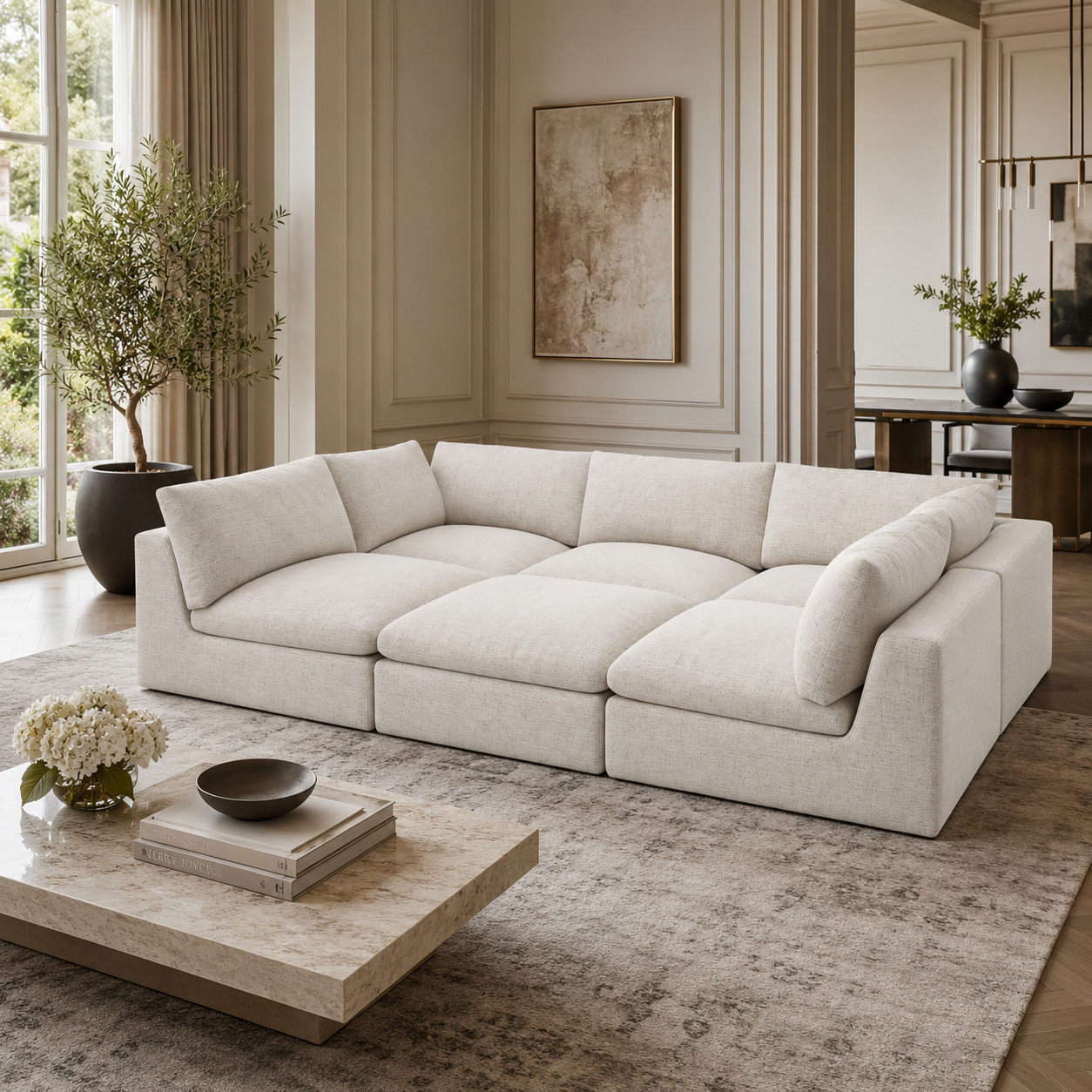 Luxury beige sectional sofa in modern living room with marble coffee table and large window
