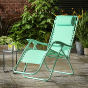 Mint green outdoor recliner chair on patio with side table and plants, perfect for garden relaxation.