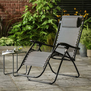 Grey outdoor recliner chair with black frame on patio, perfect for garden relaxation