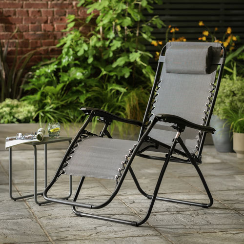 Grey outdoor recliner chair with black frame on patio, perfect for garden relaxation