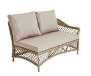 Wicker outdoor sofa with beige cushions, perfect for patio or garden seating