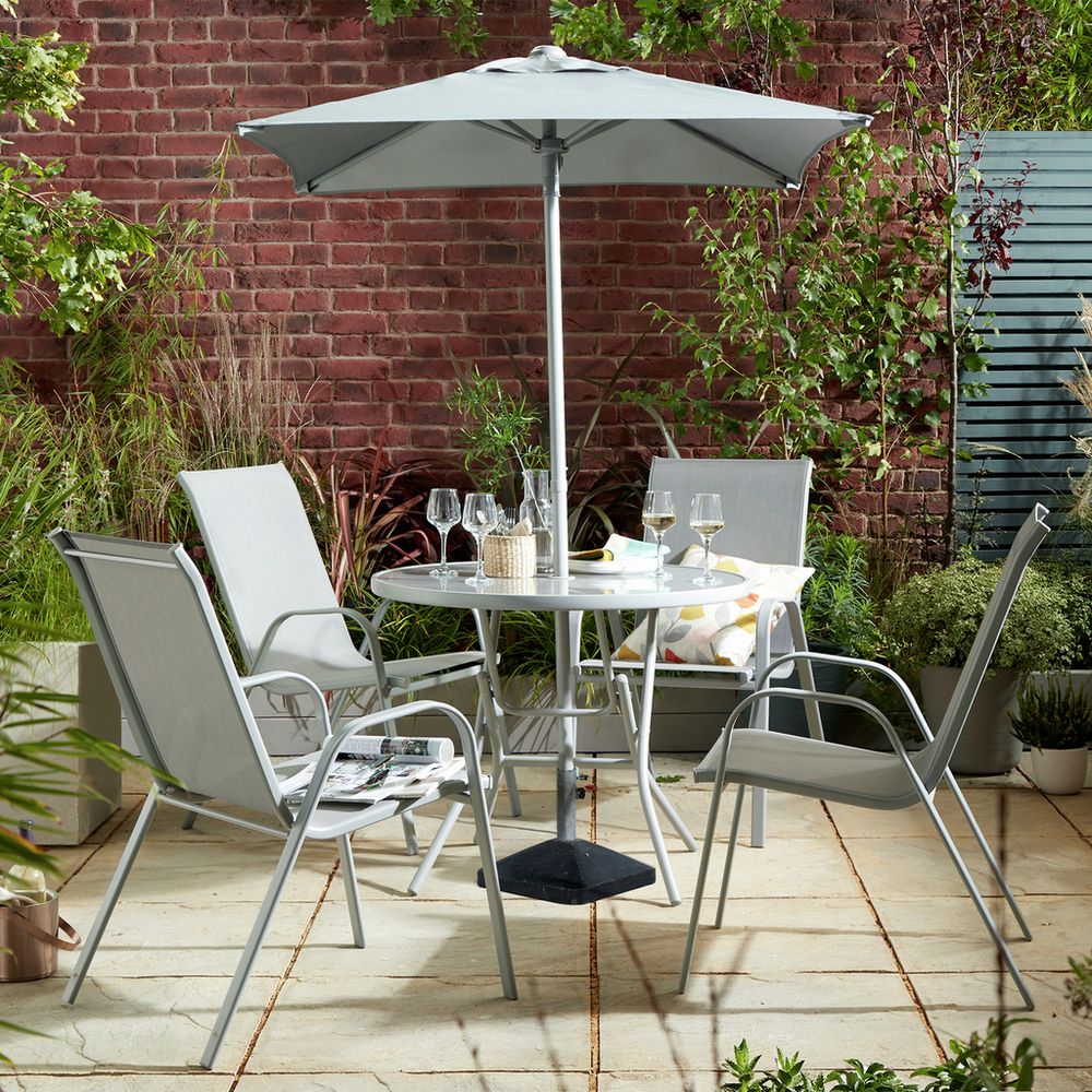 Grey outdoor dining set with umbrella, chairs, and table on patio, perfect for garden dining