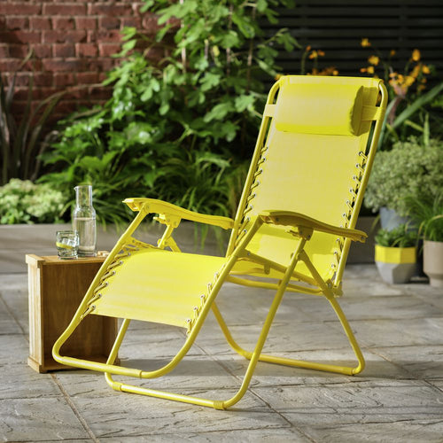 Bright yellow outdoor lounge chair on patio with greenery, perfect for garden relaxation and summer comfort.