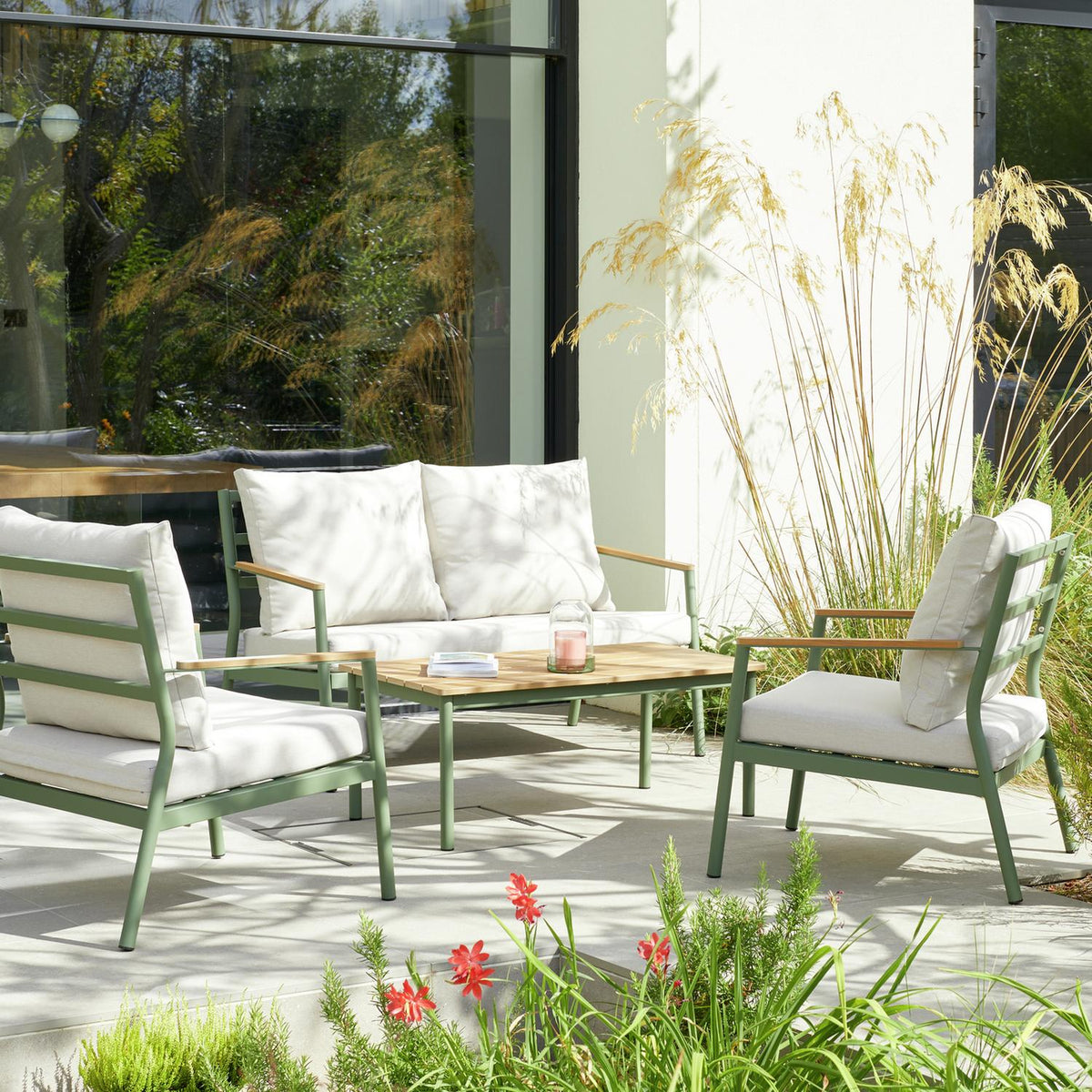 Green outdoor sofa set with white cushions on patio, modern garden furniture for luxury living spaces