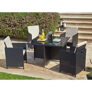 Black wicker outdoor dining set with cream cushions, glass table, and breakfast setup on patio