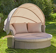 Luxury wicker garden daybed with canopy, plush cushions, perfect for outdoor relaxation in UK gardens