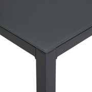 Modern black glass-top table with sleek metal legs, contemporary dining furniture