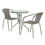 Grey outdoor bistro set with round glass-top table and two woven armchairs, perfect for patios or balconies.