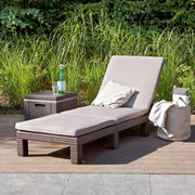 Luxury outdoor wicker chaise lounge with beige cushion on patio, perfect for garden relaxation