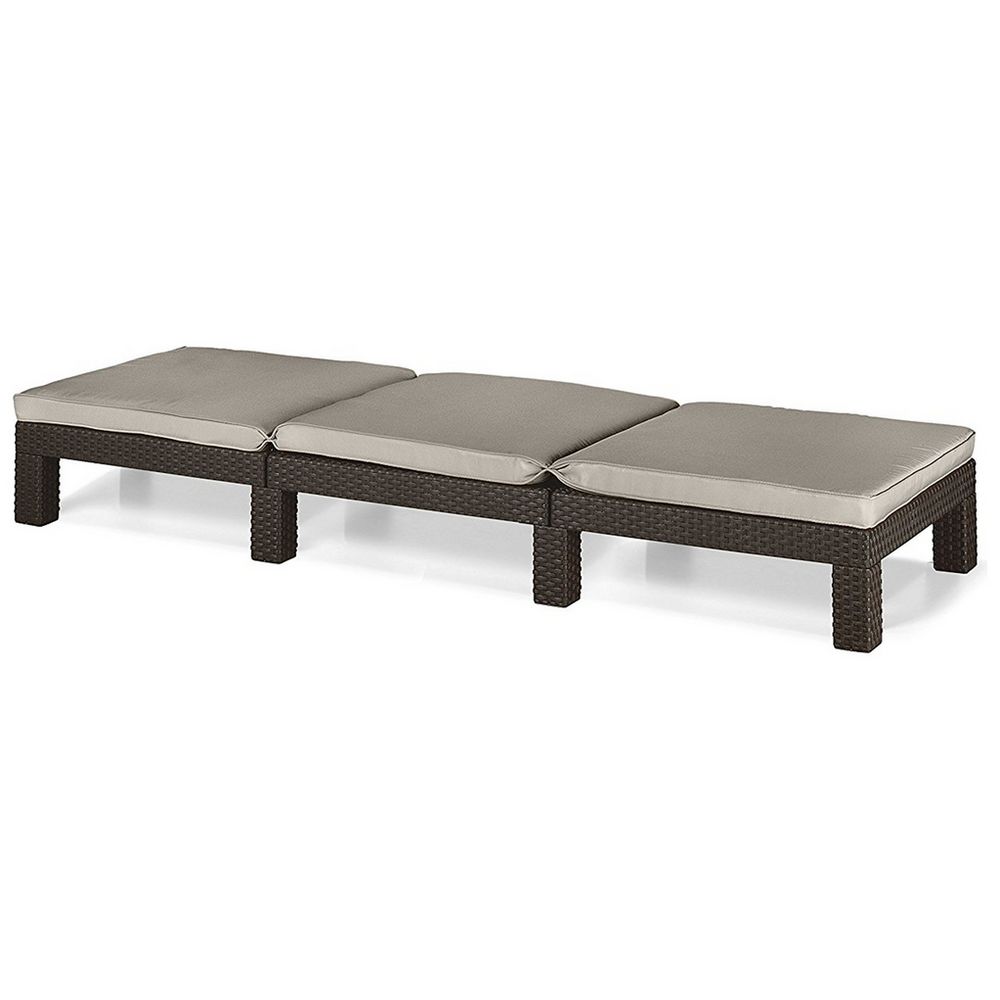 Outdoor wicker lounge with three beige cushions, ideal for patio or garden relaxation