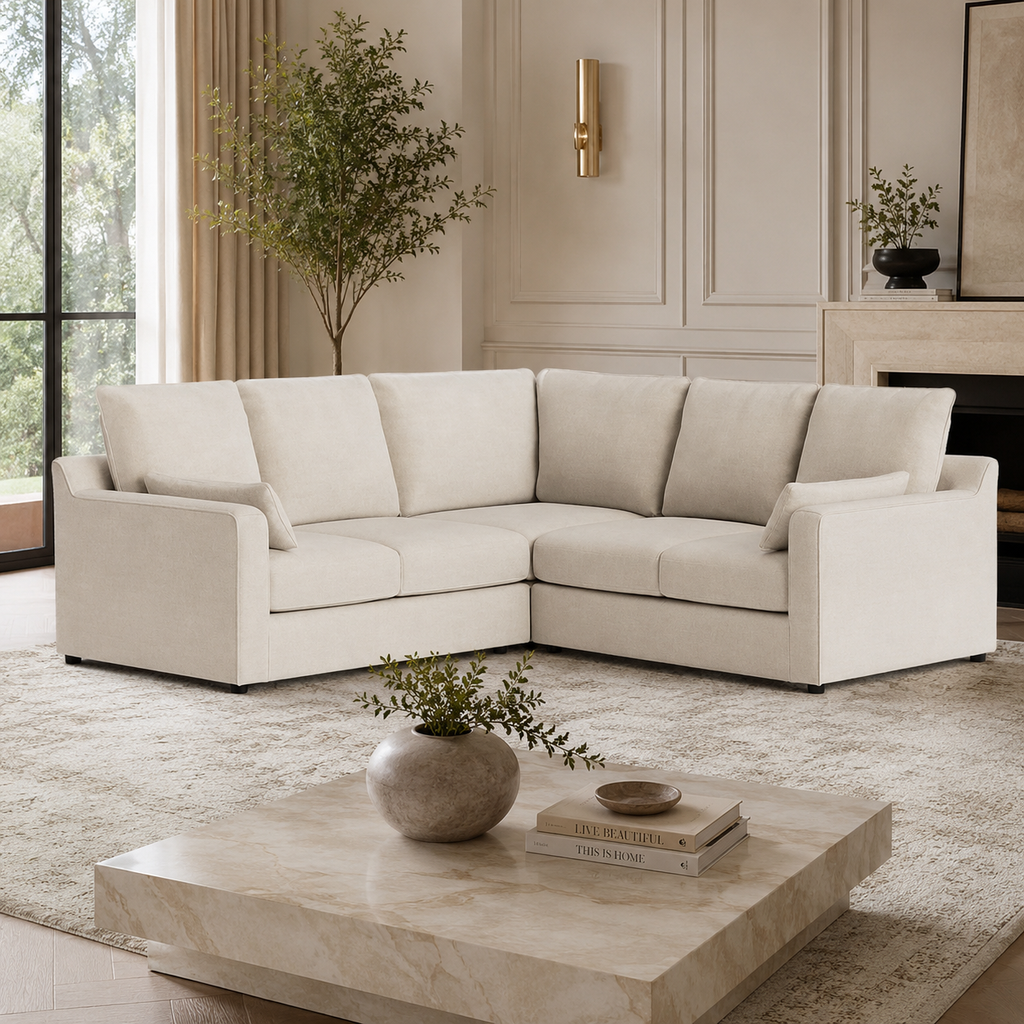 Luxury beige sectional sofa in modern living room with marble coffee table and greenery