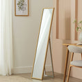 Full-length wooden floor mirror in modern bedroom with neutral decor and natural light