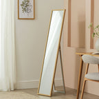 Full-length wooden floor mirror in modern bedroom with neutral decor and natural light
