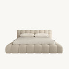 Modern beige upholstered bed with tufted headboard and two pillows, luxury bedroom furniture