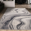 Gray and white abstract wave pattern area rug in modern living room with wooden floors