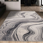Gray and white abstract wave pattern area rug in modern living room with wooden floors