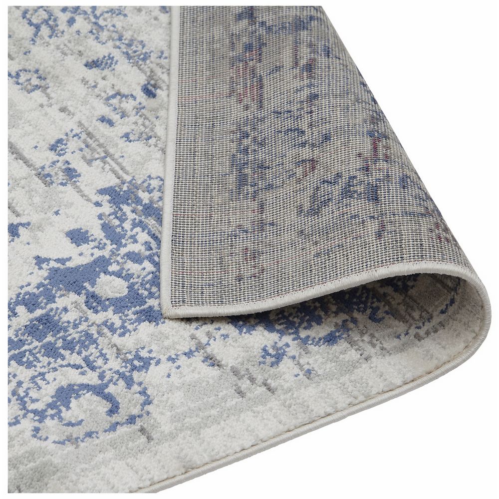 Blue and white distressed pattern area rug with textured weave and stitched edge