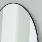 Round wall mirror with sleek black frame, modern minimalist home decor