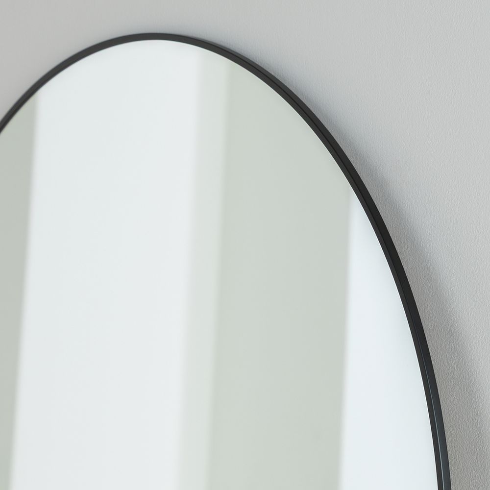 Round wall mirror with sleek black frame, modern minimalist home decor