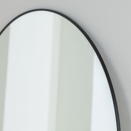 Round wall mirror with sleek black frame, modern minimalist home decor