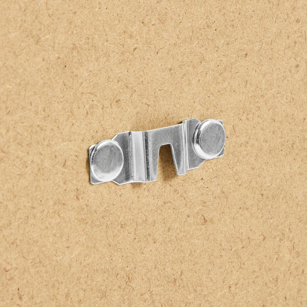 Metal sofa bed connector hardware on cardboard background