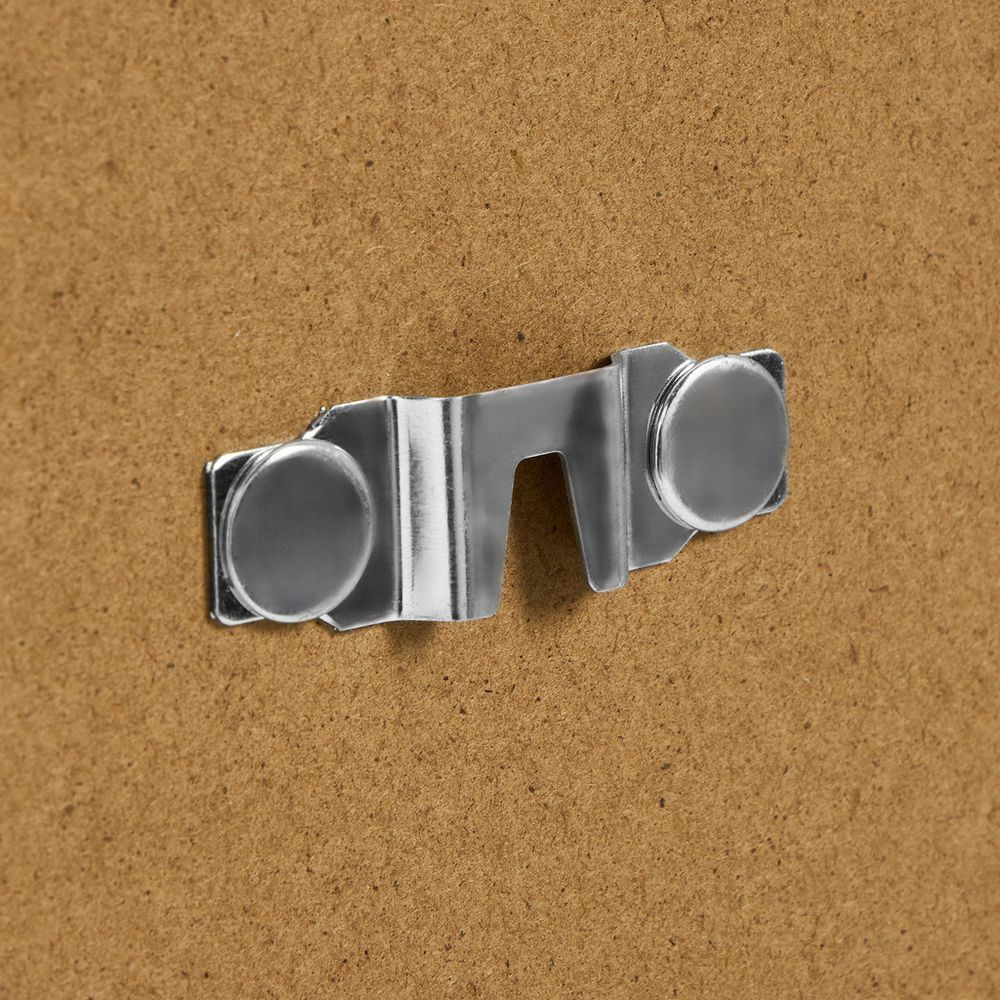 Chrome metal sofa leg cap with circular feet on cork background