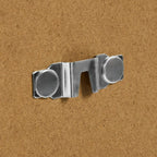 Chrome metal sofa leg cap with circular feet on cork background
