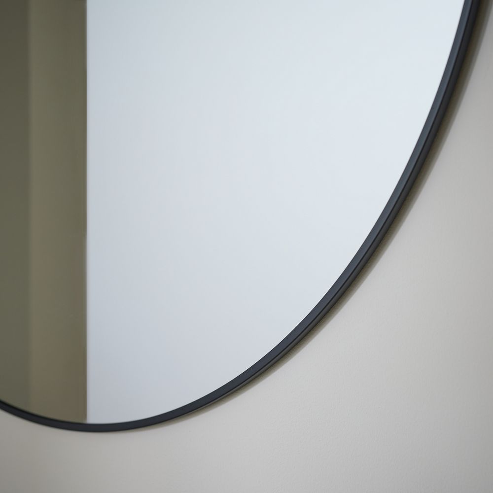 Round wall mirror with sleek black frame, modern home decor accent
