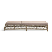 Wicker outdoor daybed with beige cushions, perfect for luxury patio furniture